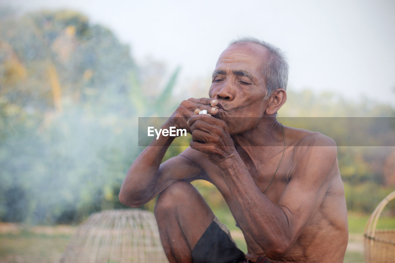 PORTRAIT OF MAN HOLDING LEAF