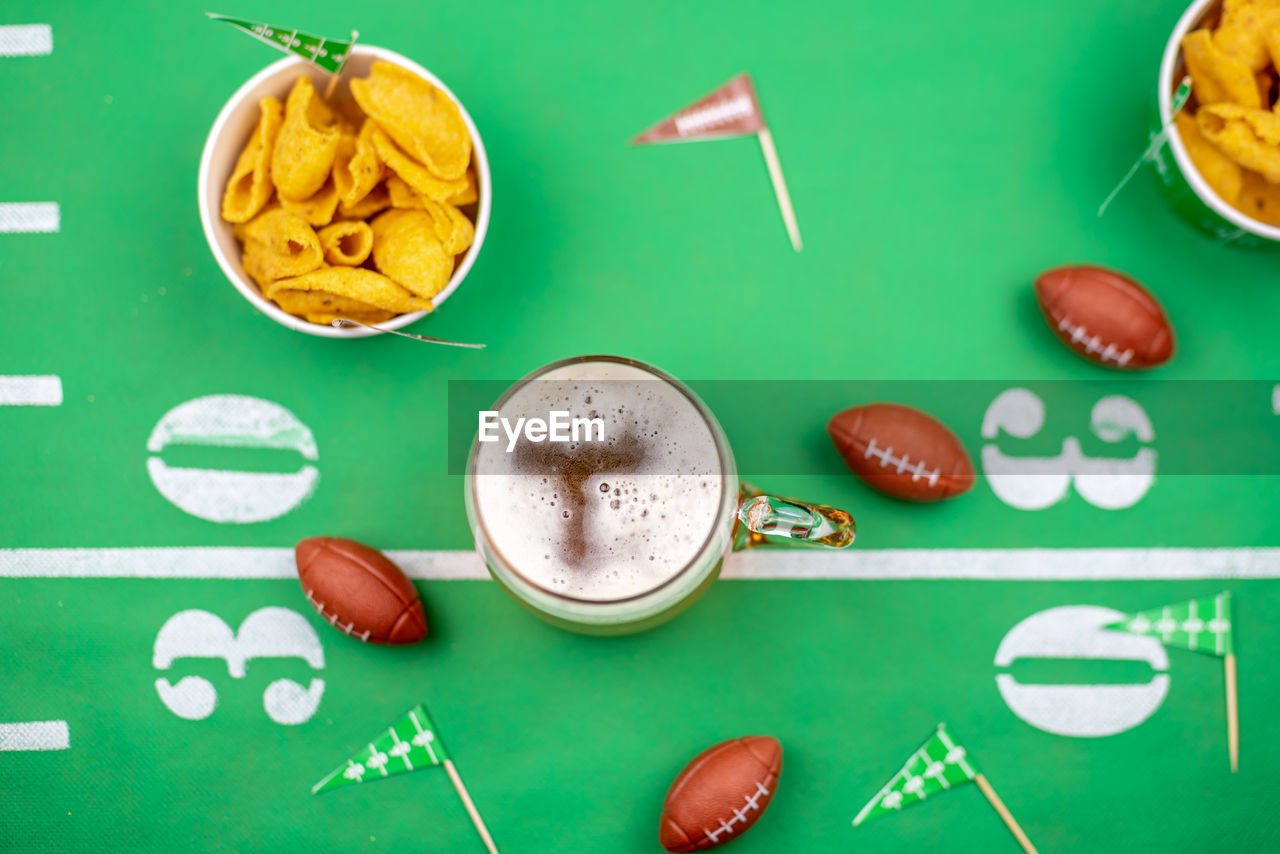 Fun game day snacks on football decorated table for superbowl
