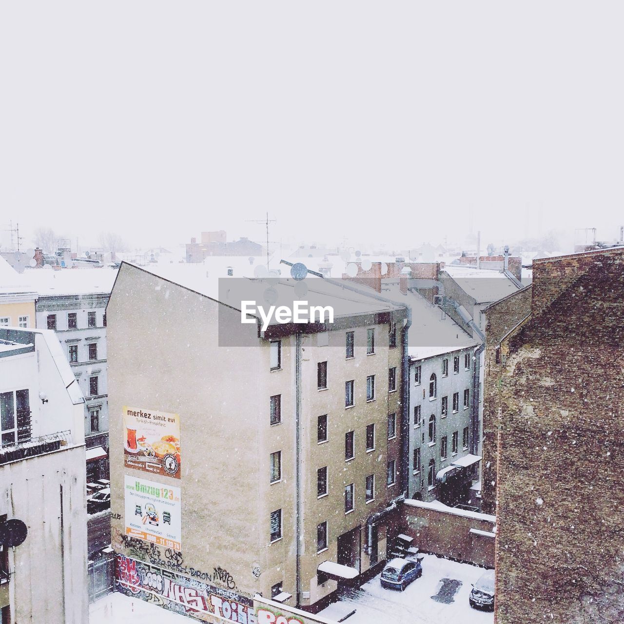 Exterior of buildings against sky in city during winter