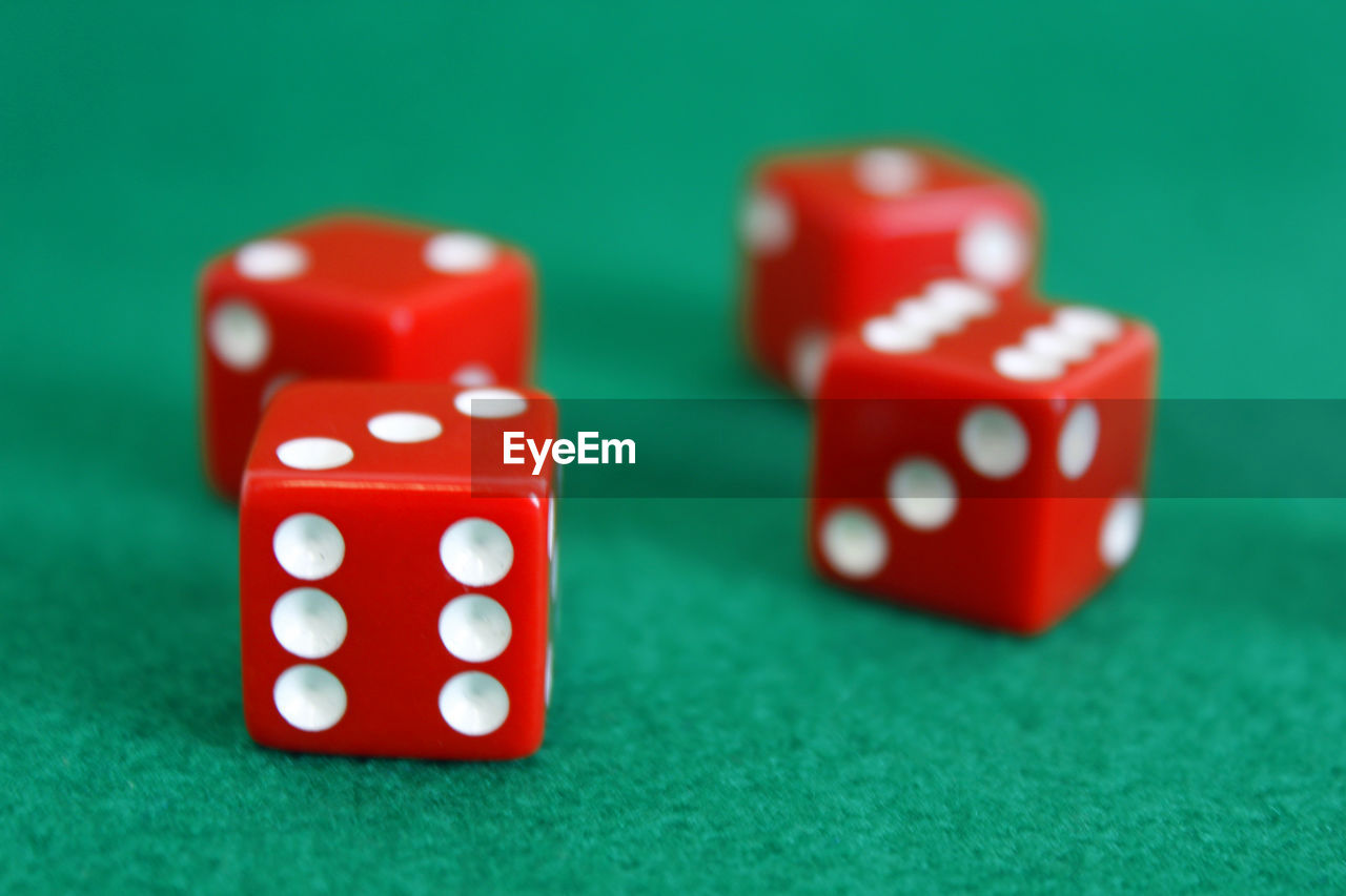 Close-up of red dice on green table