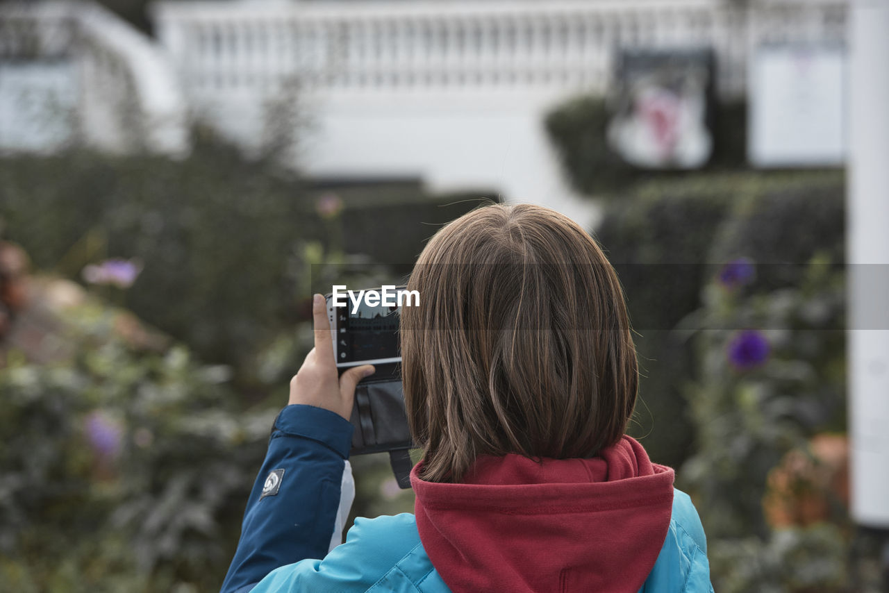 FULL LENGTH PORTRAIT OF WOMAN PHOTOGRAPHING WITH MOBILE PHONE