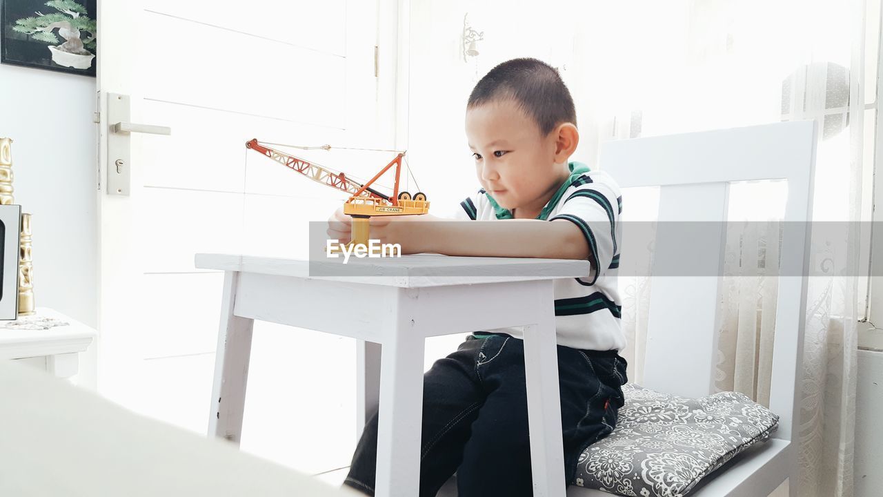 Boy playing with toy at home