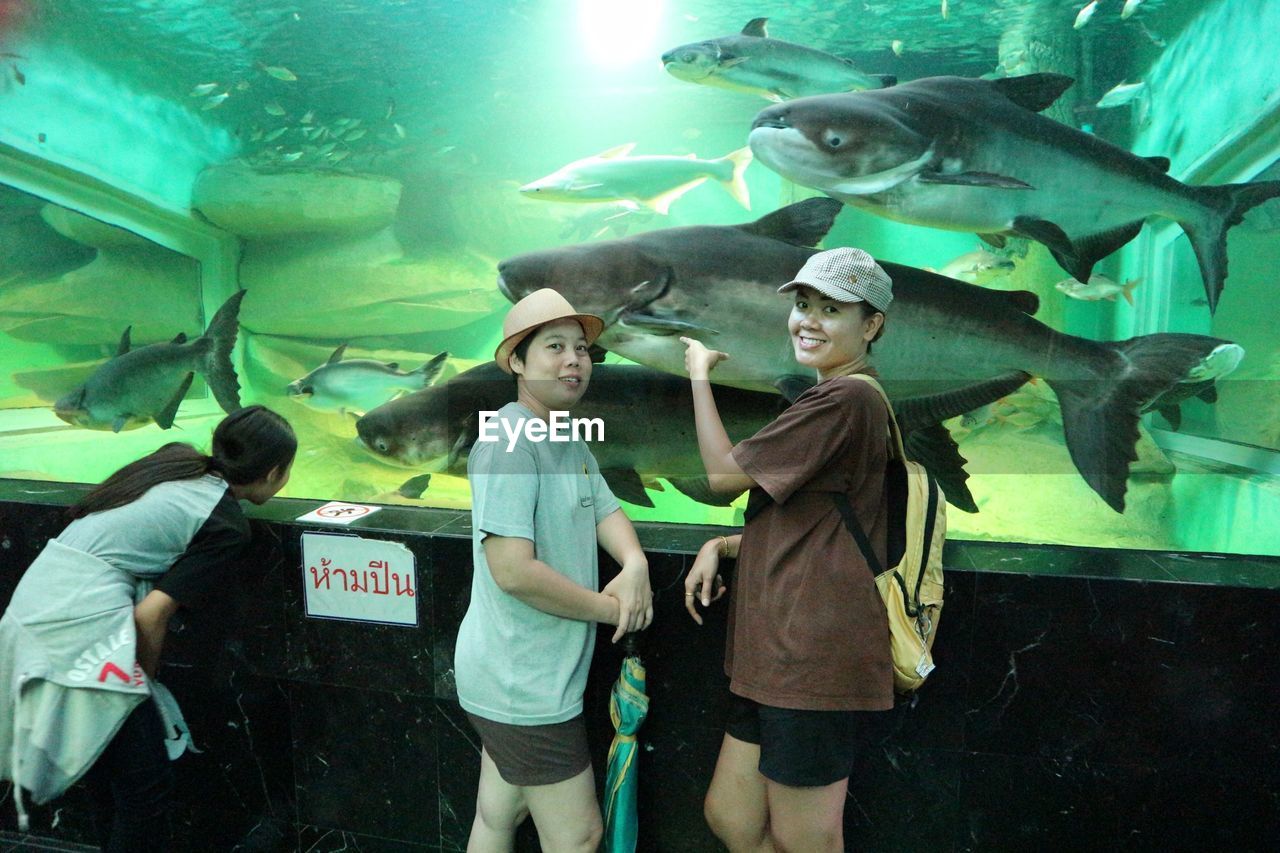 GROUP OF PEOPLE IN AQUARIUM