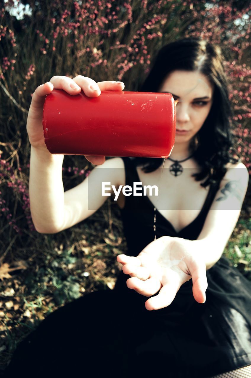 Young woman holding red candle