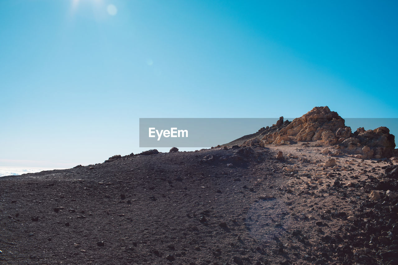 Scenic view of arid landscape against sky