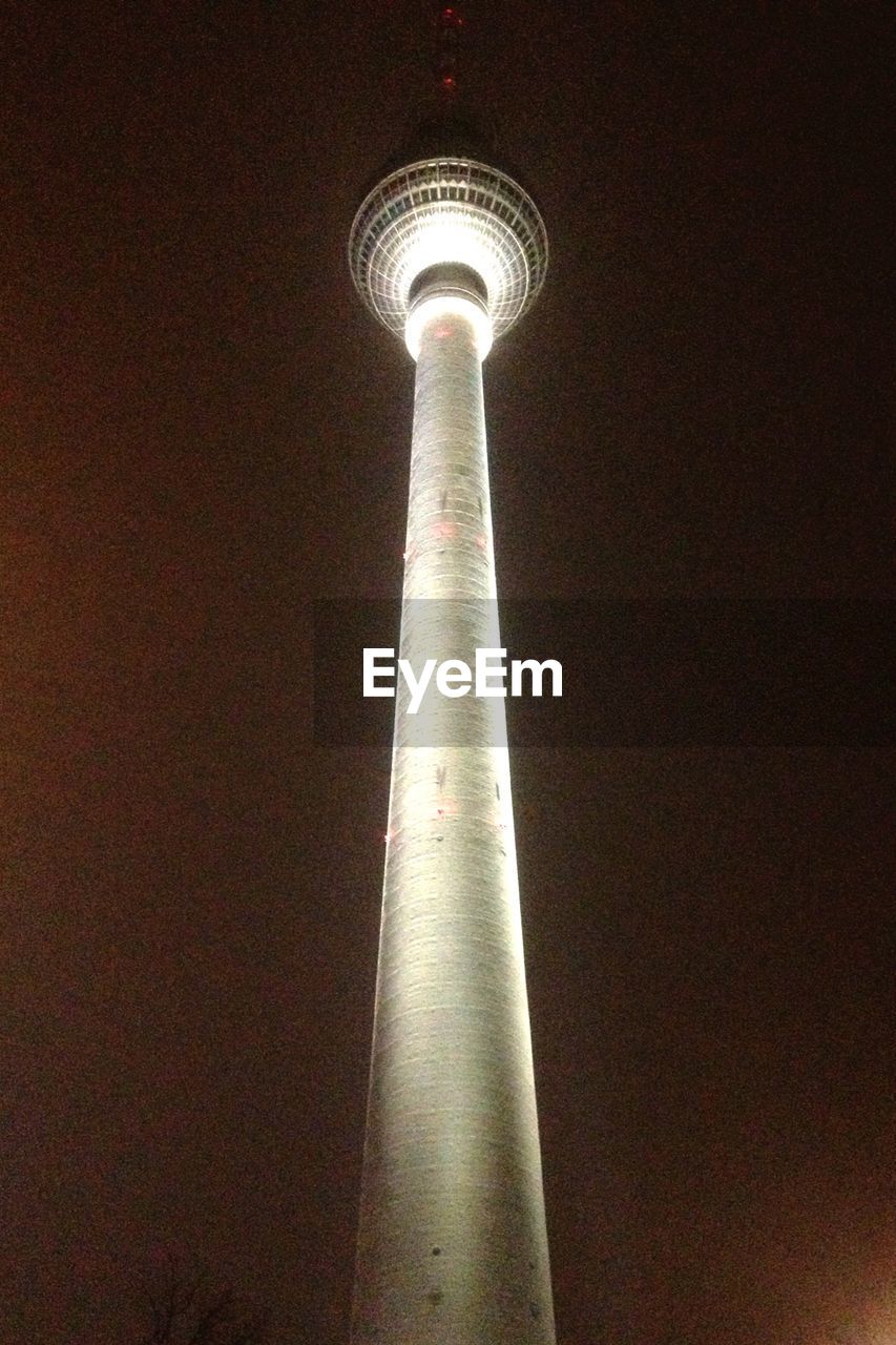 Low angle view of telecommunications tower at night