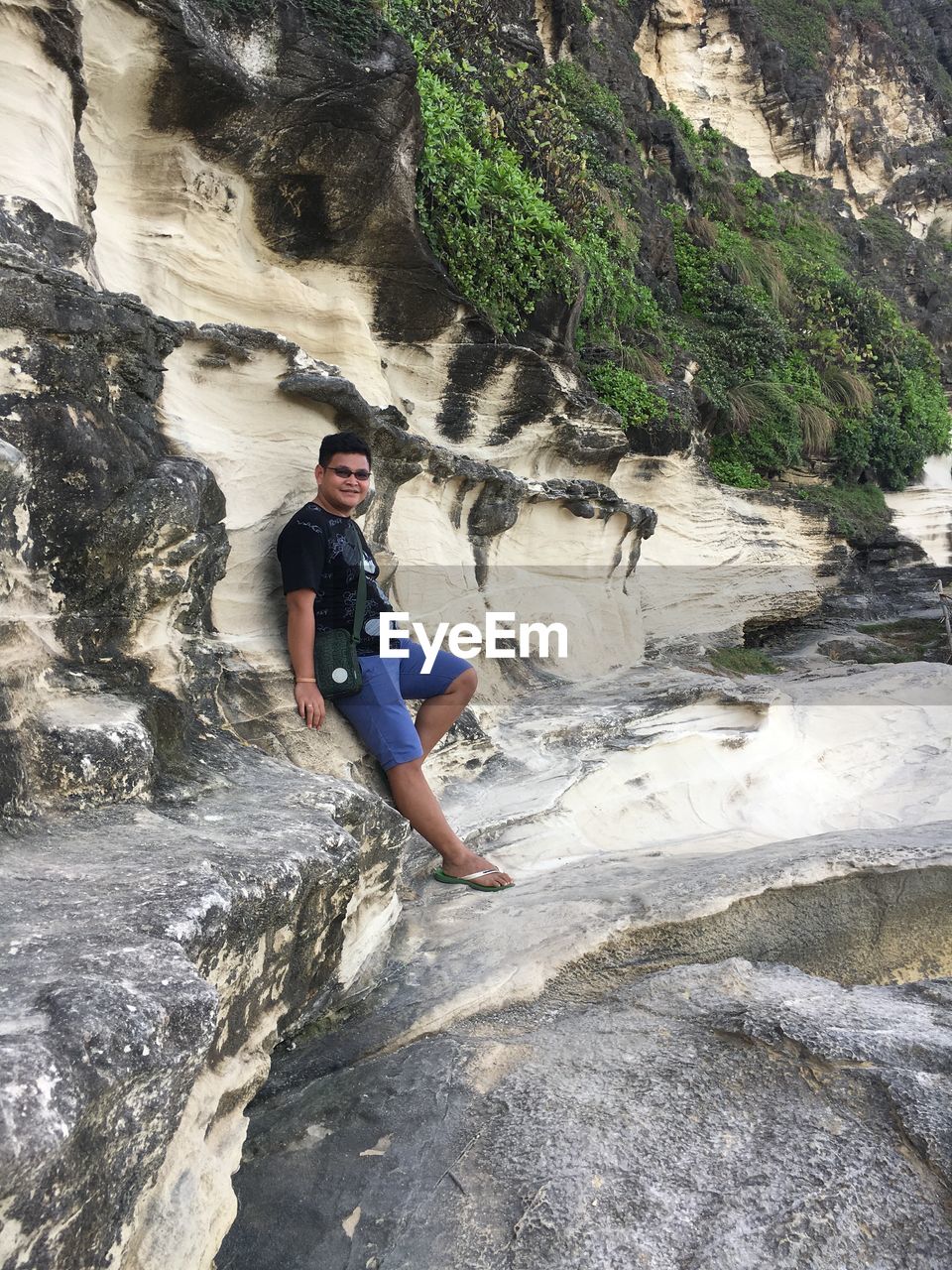 Full length of man standing on rock formation