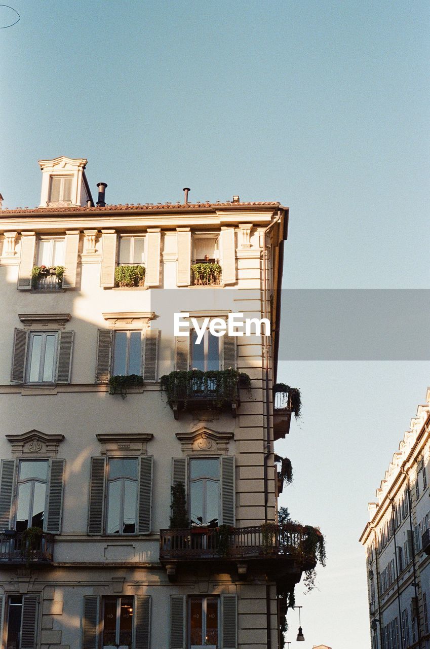 Low angle view of buildings against clear sky