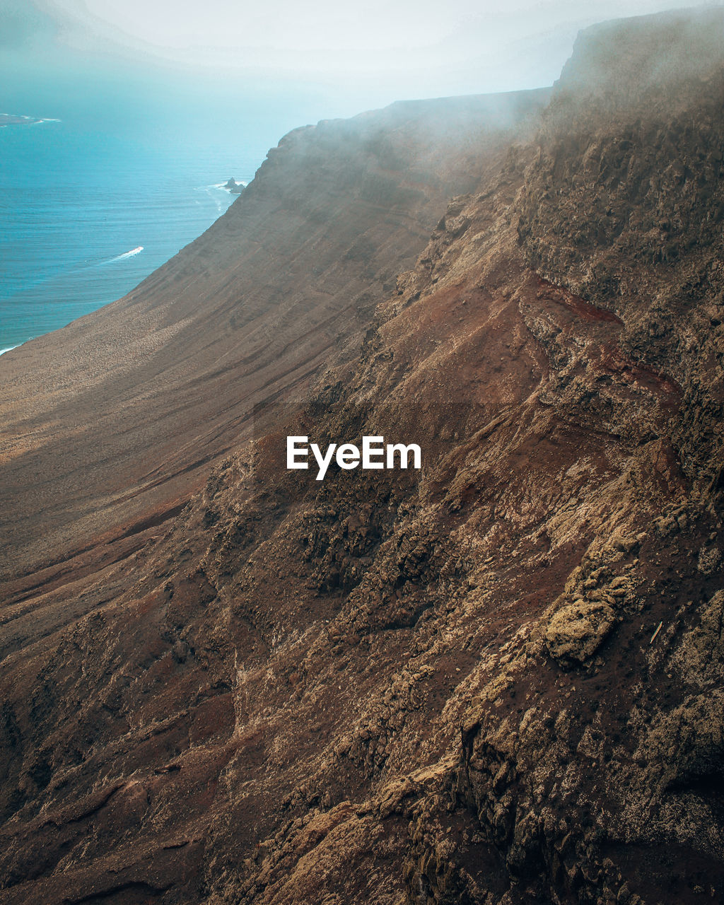 High angle view of a cliff againts clouds. lanzarote.