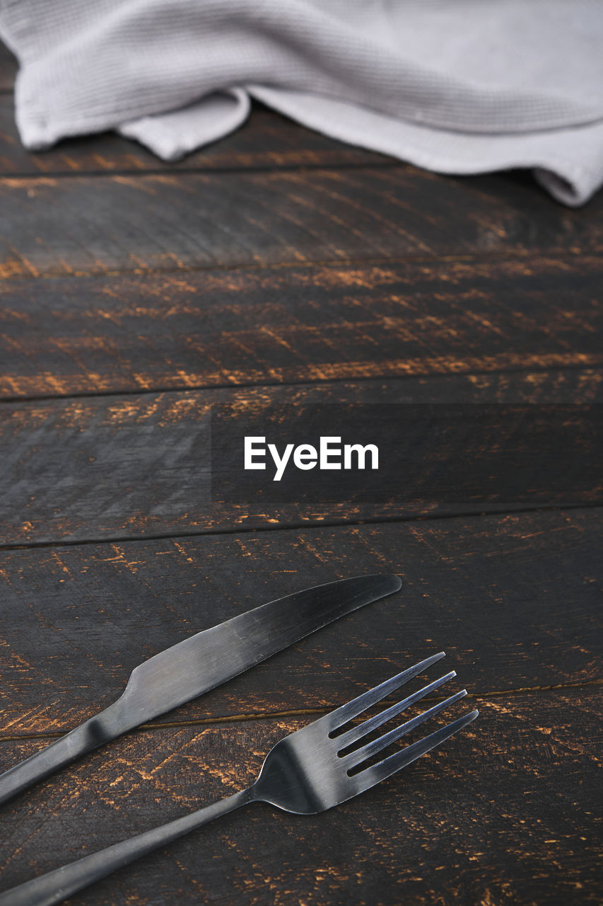Decorated cutlery, fork and knife on a blue napkin. mockup