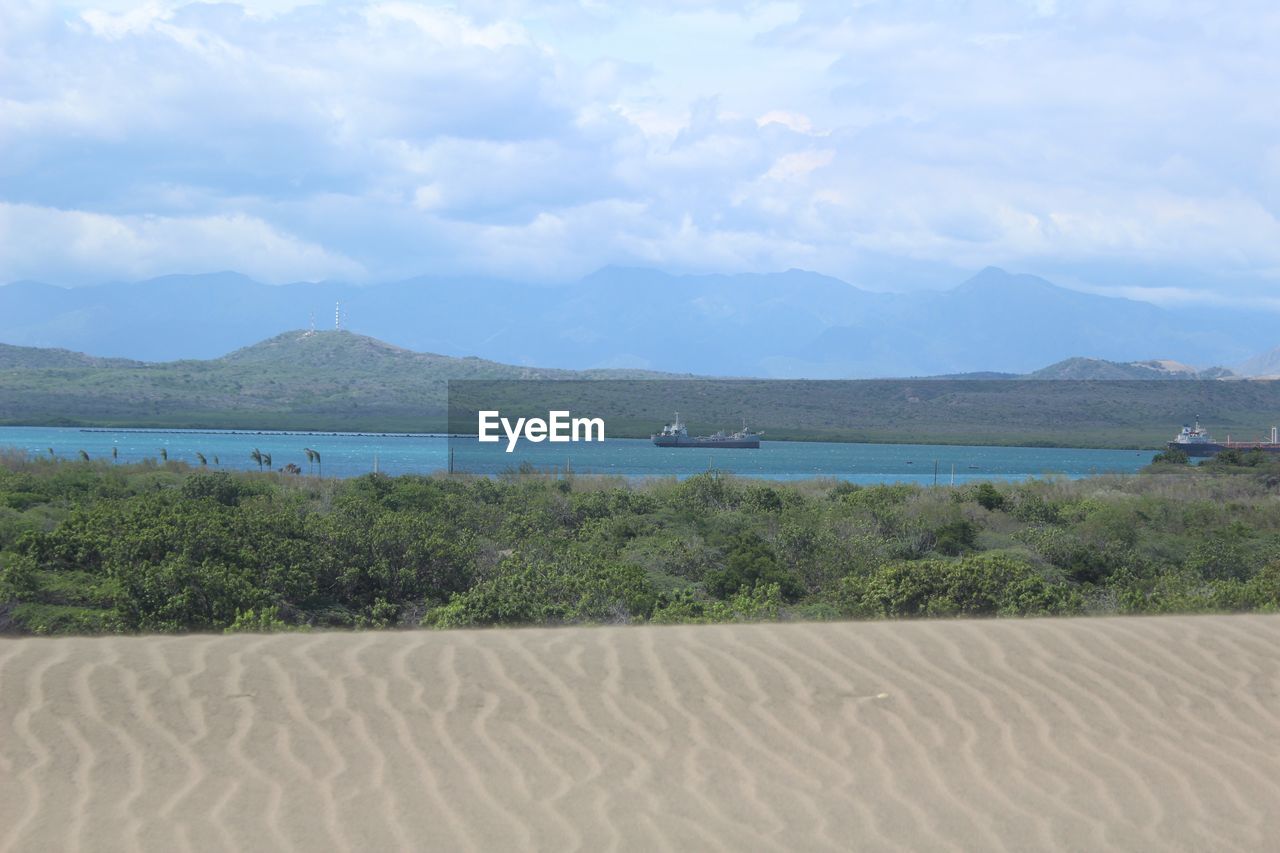 Scenic view of mountains against cloudy sky