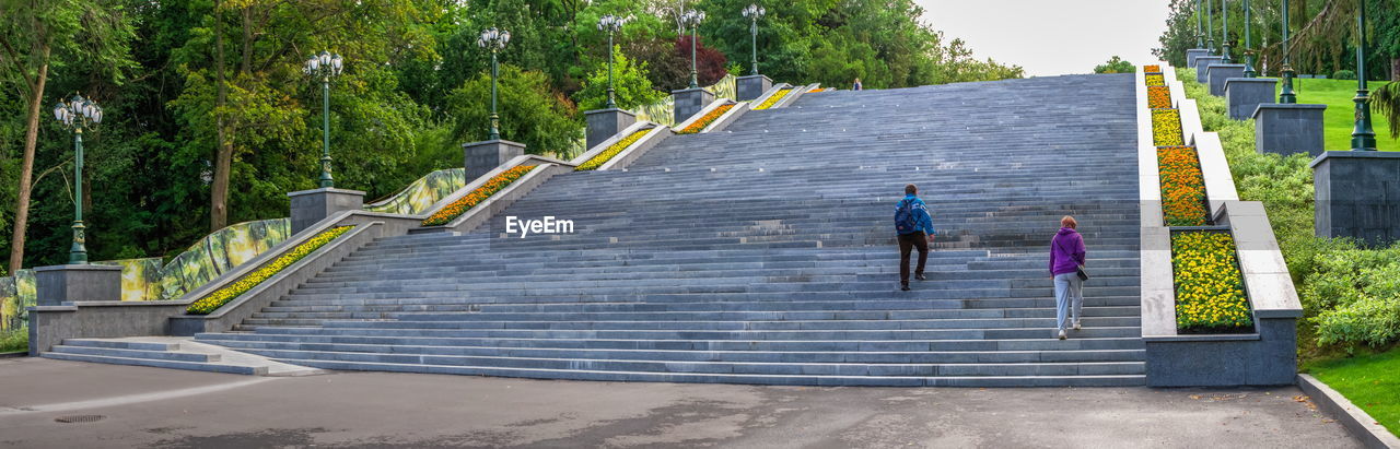 REAR VIEW OF PEOPLE ON STEPS