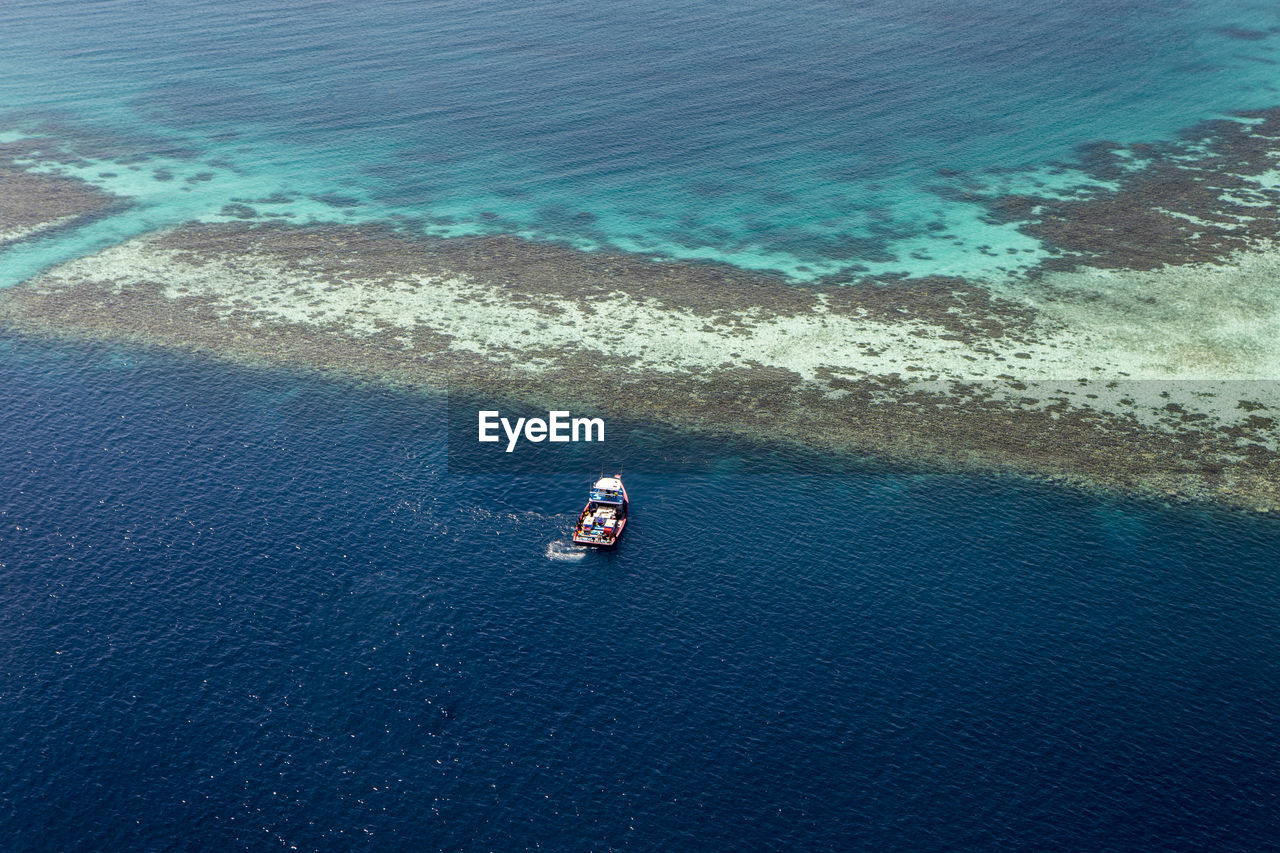 Coral reef and detail of atoll in indian ocean, maldives, view from seaplane window