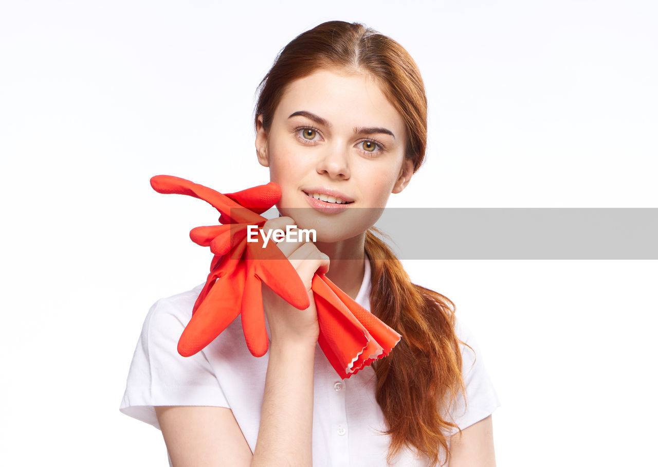 women, portrait, smiling, one person, happiness, young adult, adult, studio shot, white background, looking at camera, emotion, red, indoors, cheerful, hairstyle, female, clothing, lifestyles, cut out, positive emotion, long hair, fashion, cute, brown hair, holding, white, waist up, teeth, smile, person, child, human face, front view