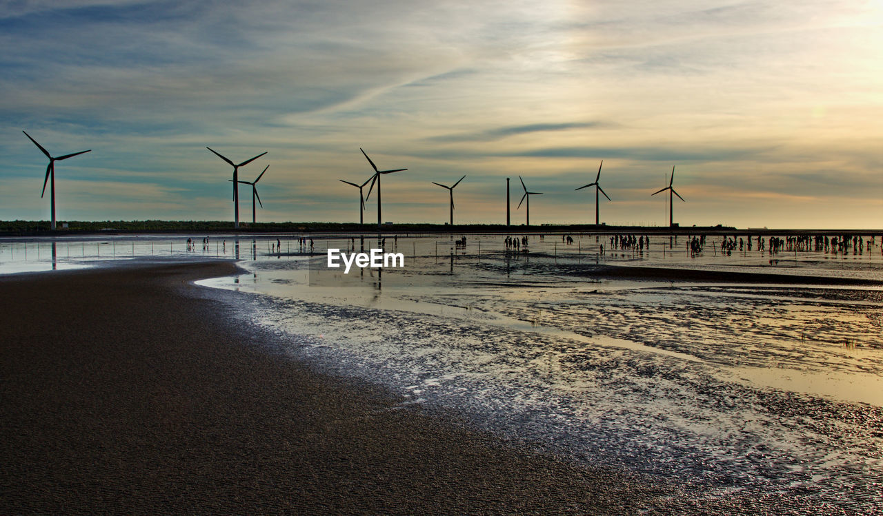 Scenic view of beach against sky during sunset
