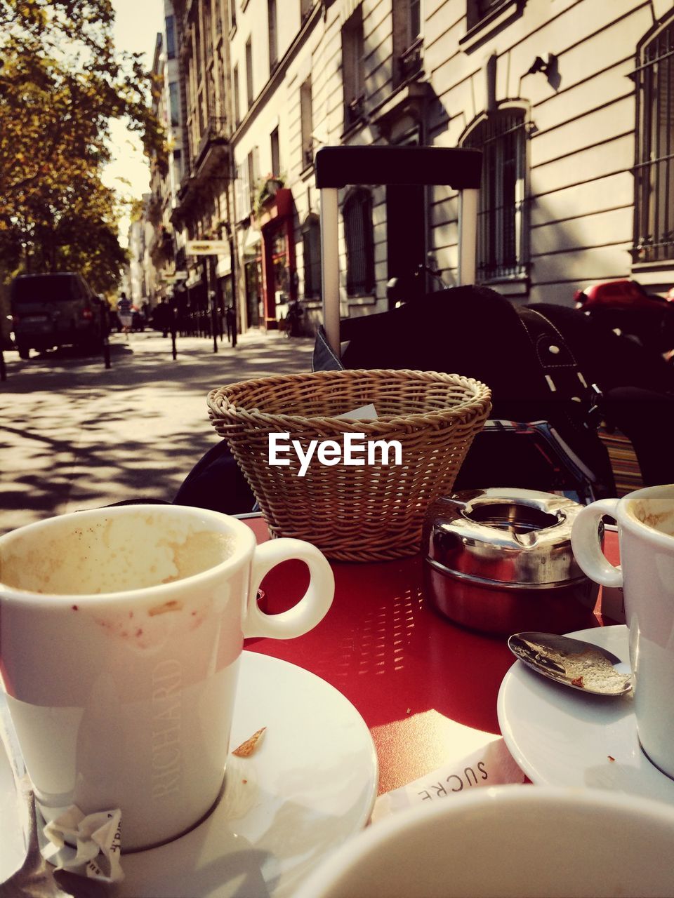 Empty coffee cups with wicker basket on table at cafe