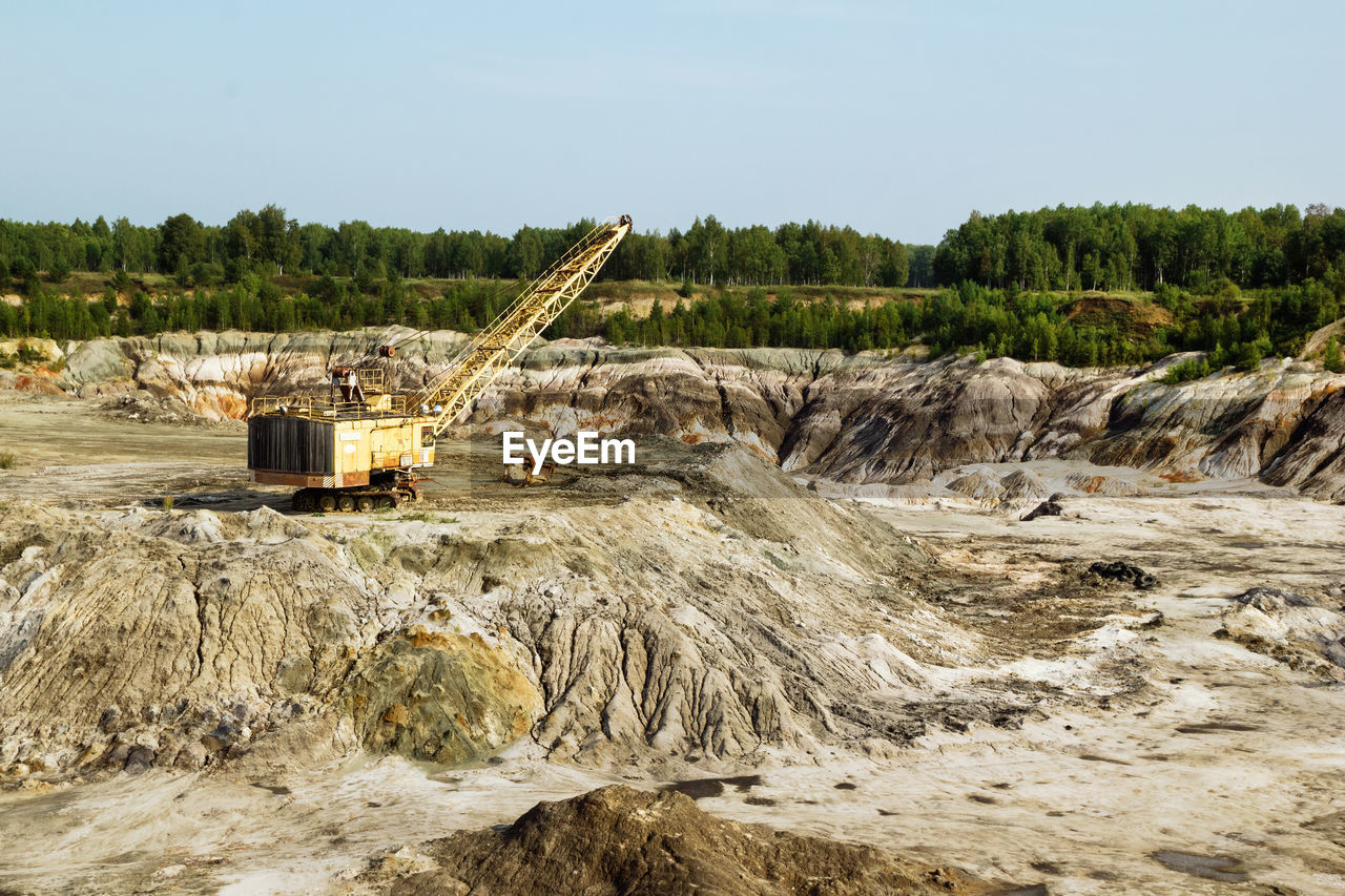 Old quarry for the extraction of clay with excavator.