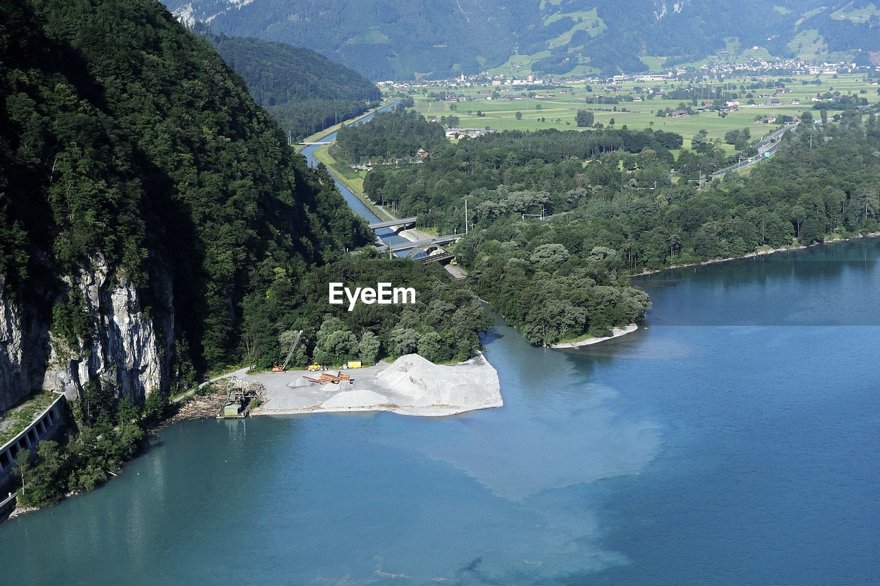 High angle view of river amidst trees against sky