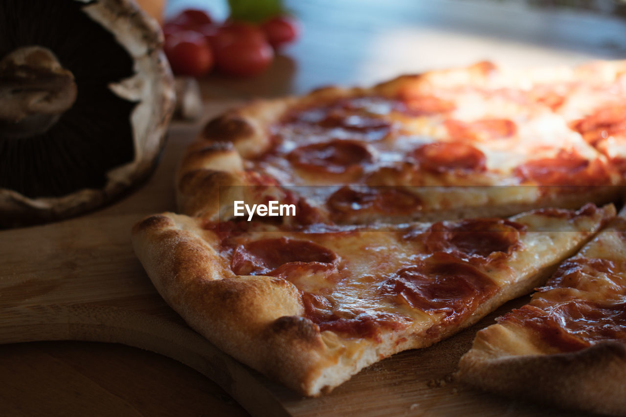 High angle view of pizza on cutting board