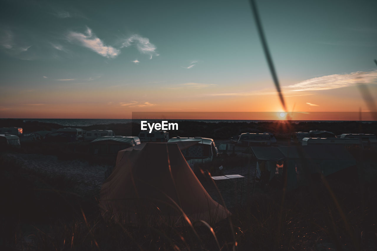 Panoramic view of sea against sky during sunset with tent