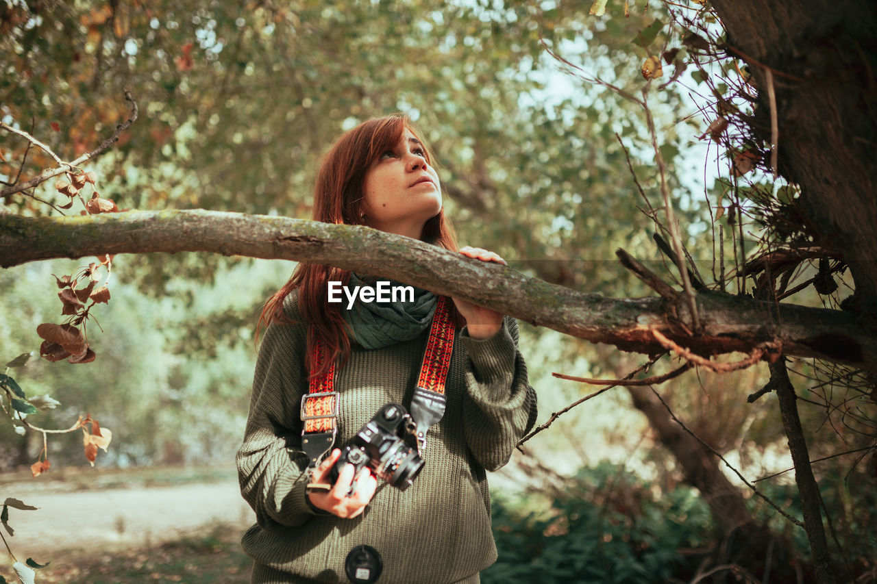 Close-up of woman standing by tree