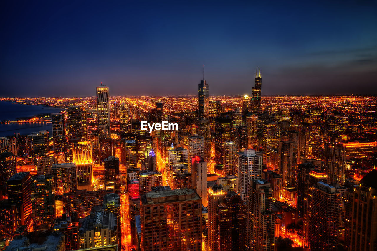 Illuminated buildings in city at night