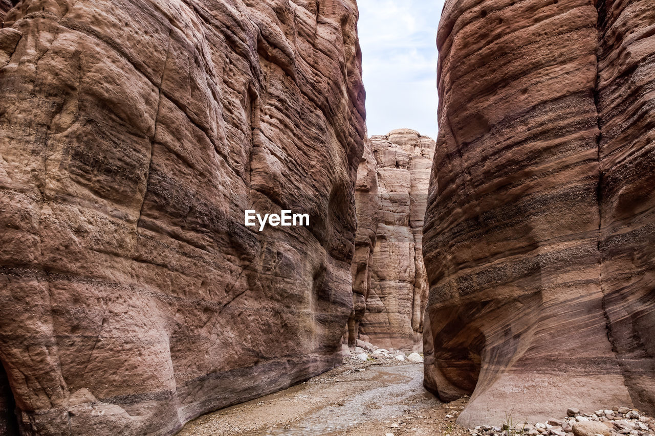 rock, rock formation, arch, nature, travel destinations, geology, ancient history, wadi, no people, canyon, non-urban scene, travel, land, scenics - nature, day, landscape, desert, beauty in nature, environment, outdoors, formation, eroded, sandstone, history, physical geography, temple, architecture, ancient, cliff, sky, tranquility, tourism, climate, the past, terrain, extreme terrain