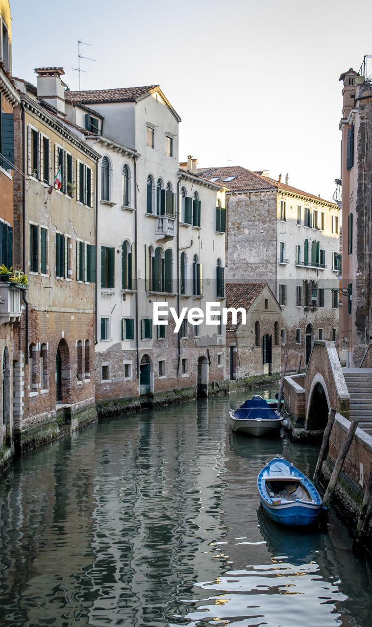 Canal passing through buildings in venice 