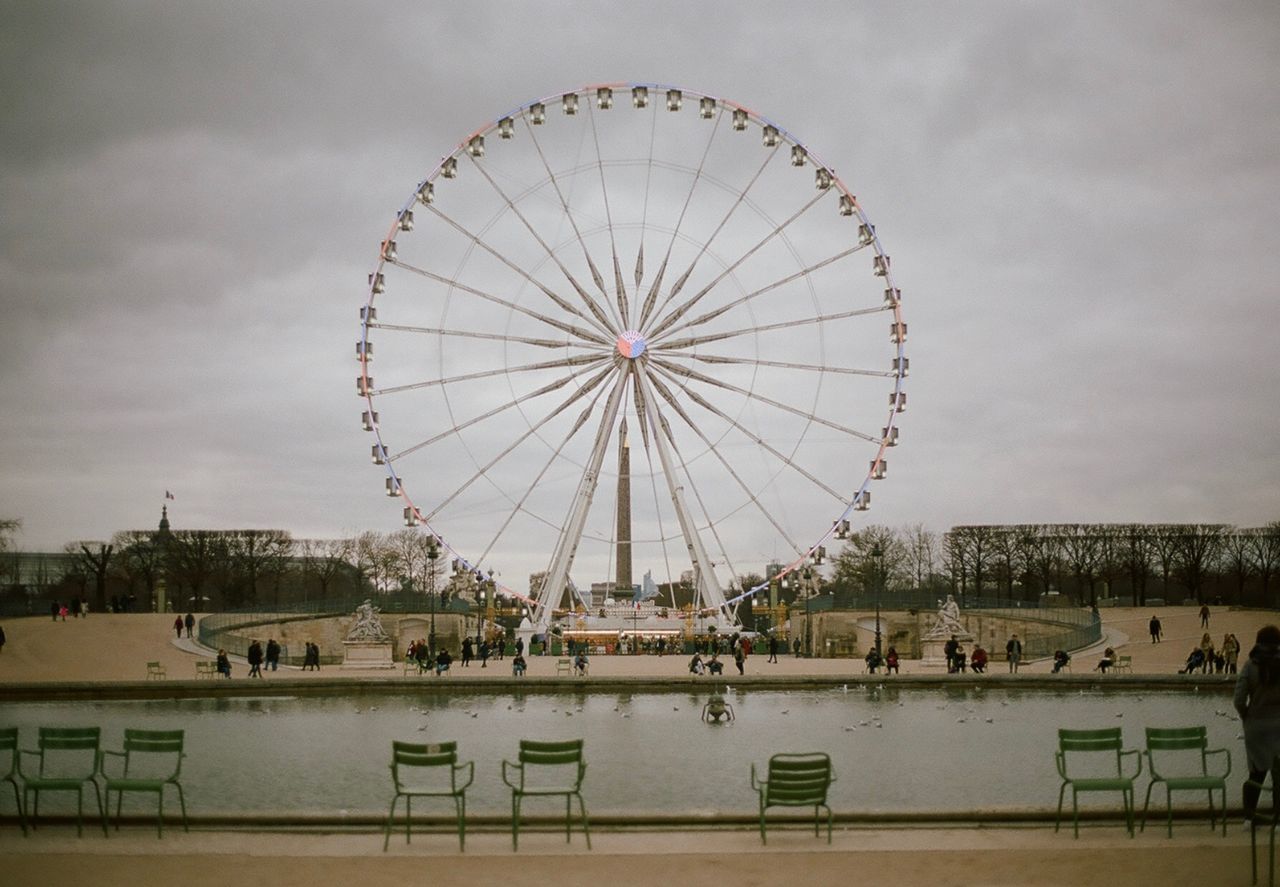 View of ferris wheel against cloudy sky