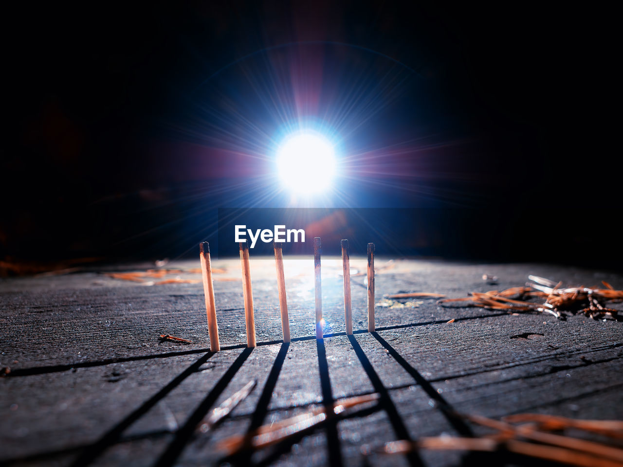 CLOSE-UP OF ILLUMINATED METALLIC STRUCTURE AGAINST SKY