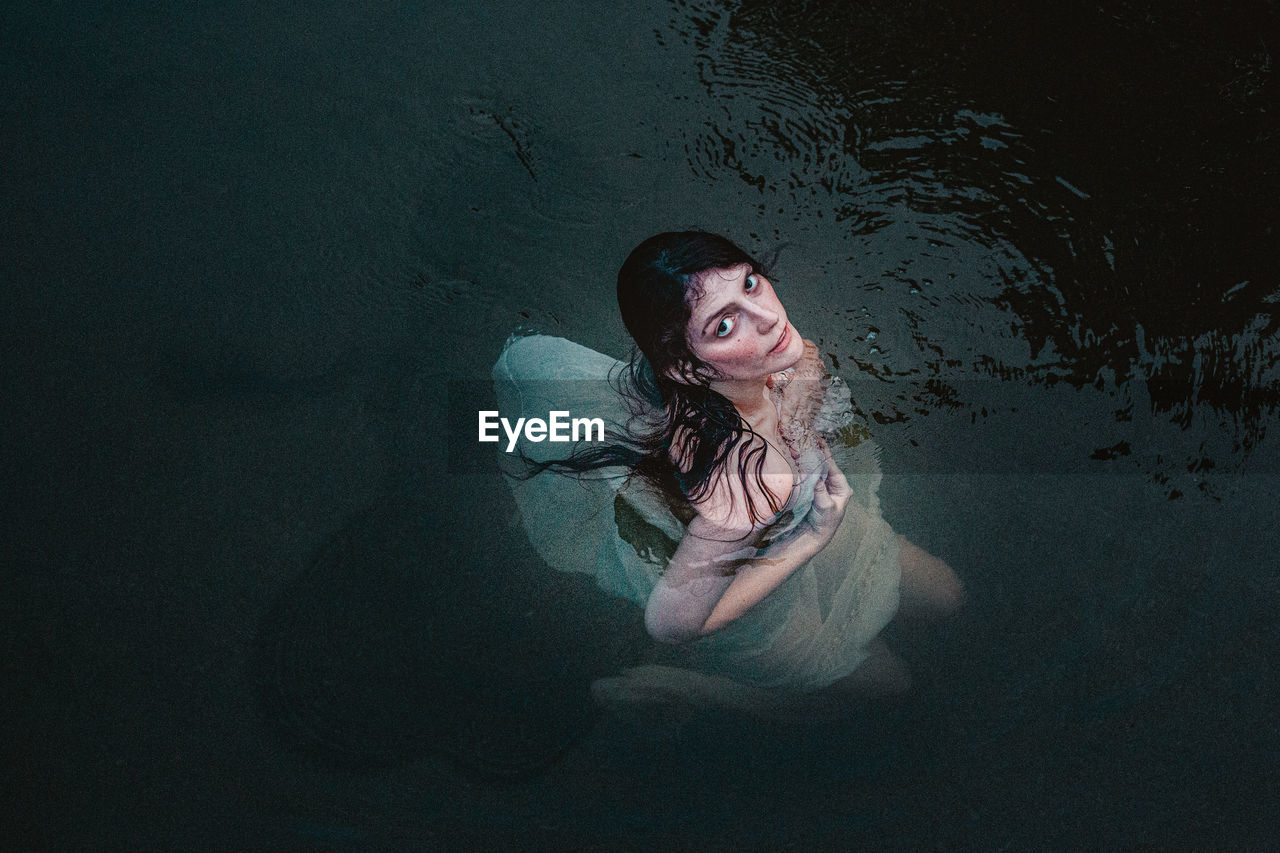 Portrait of young woman in water