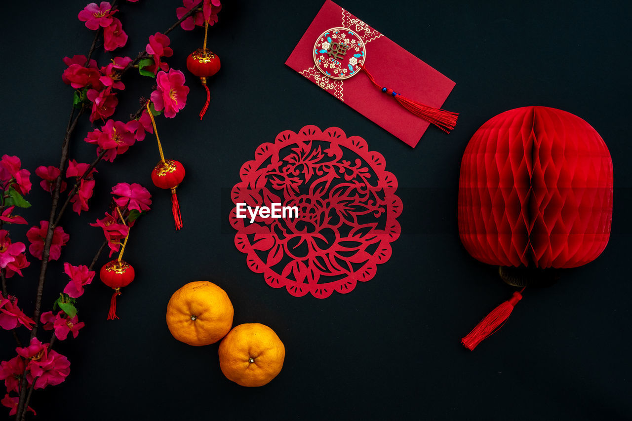Chinese lunar new year decoration over black background. flat lay concept festive decoration. 