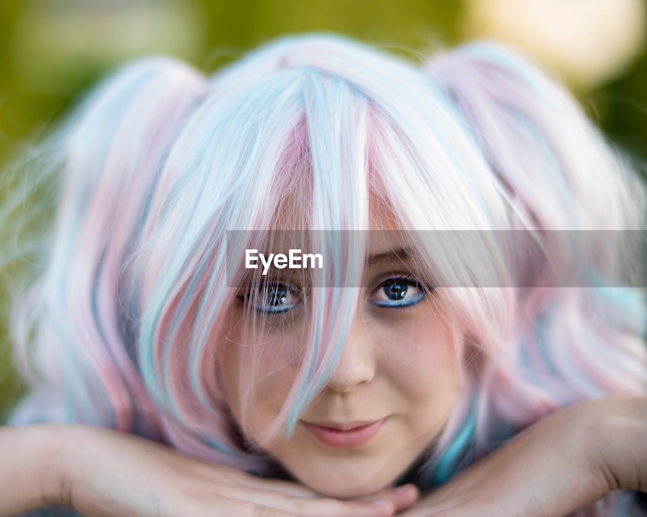 Close-up portrait of woman wearing wig and mascara