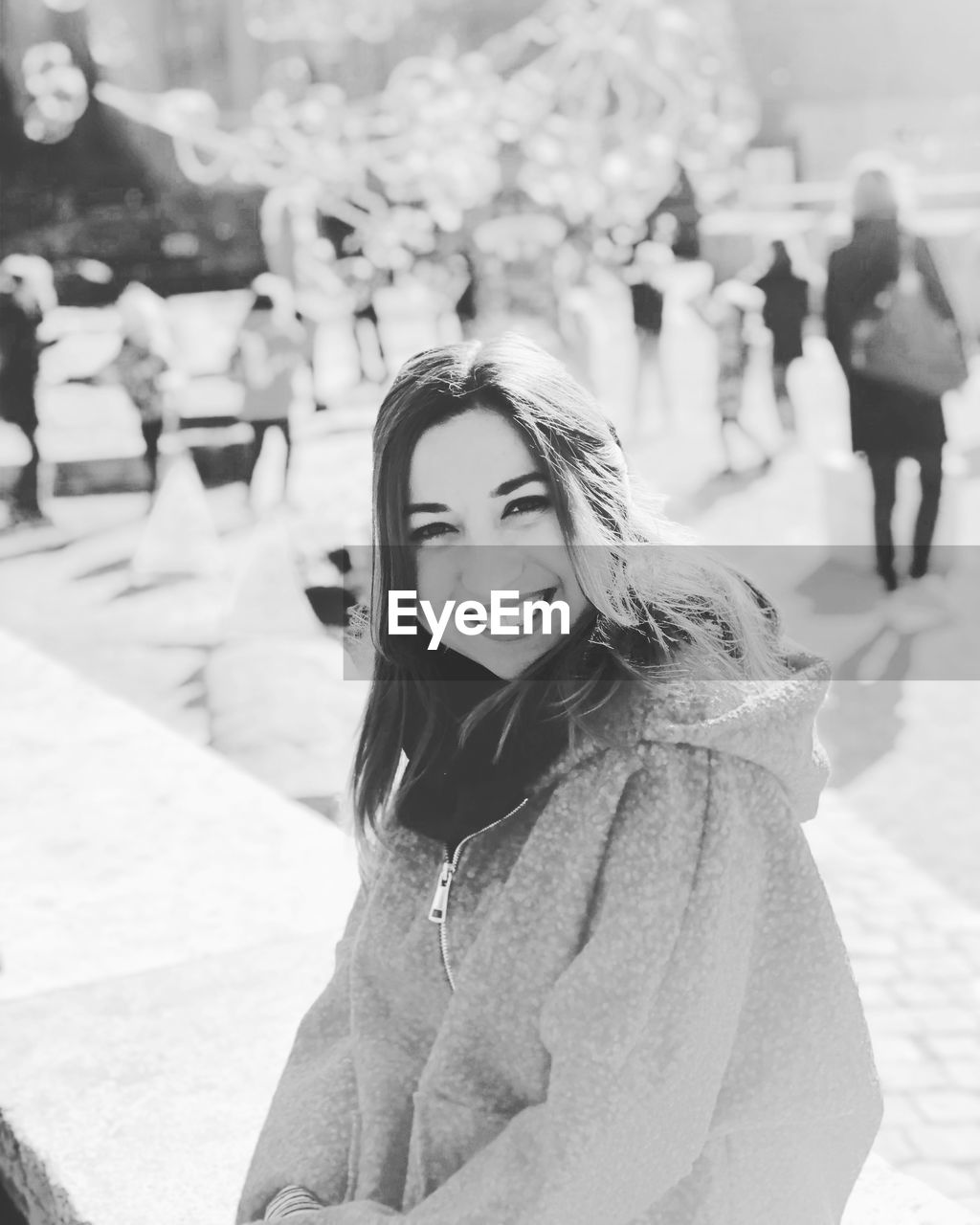 Portrait of smiling woman in park during winter