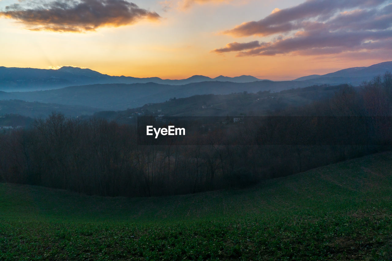 Scenic view of field against sky during sunset