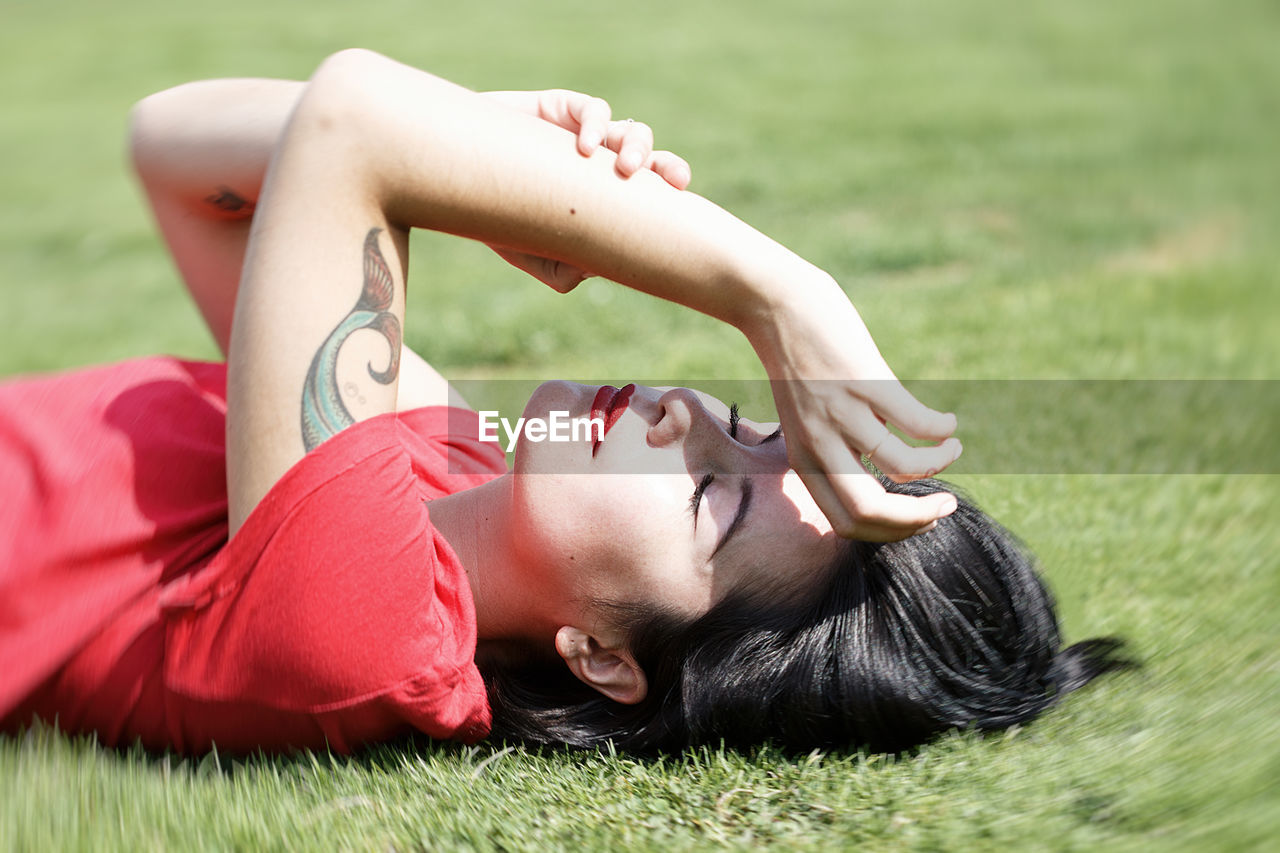 Beautiful woman lying on the grass v