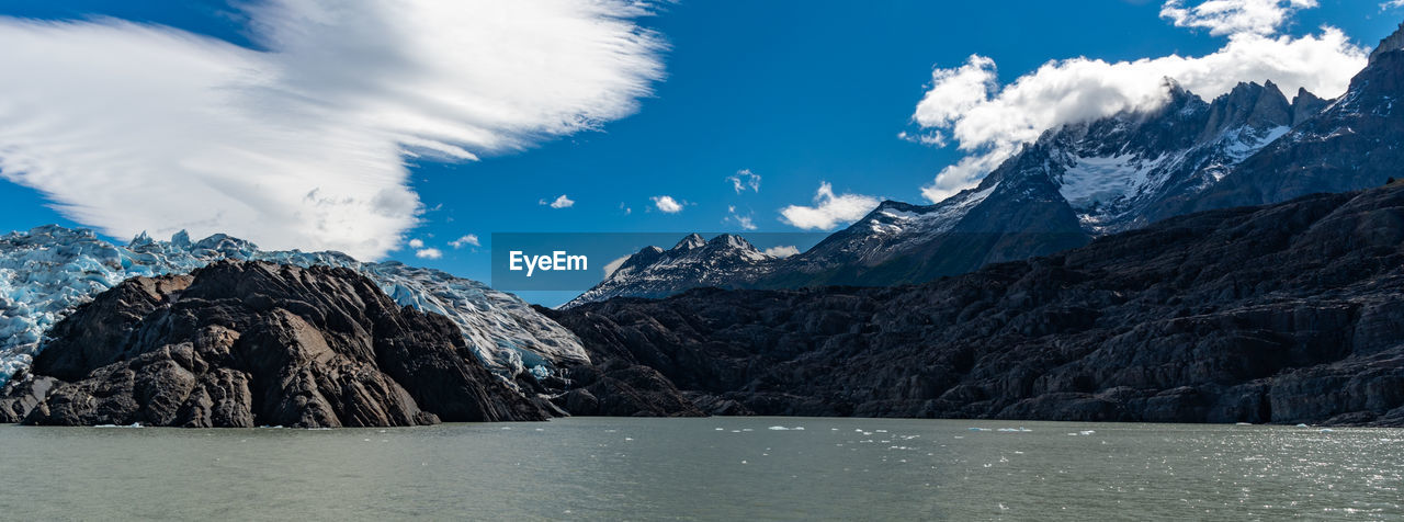 Scenic view of lake and mountains against sky