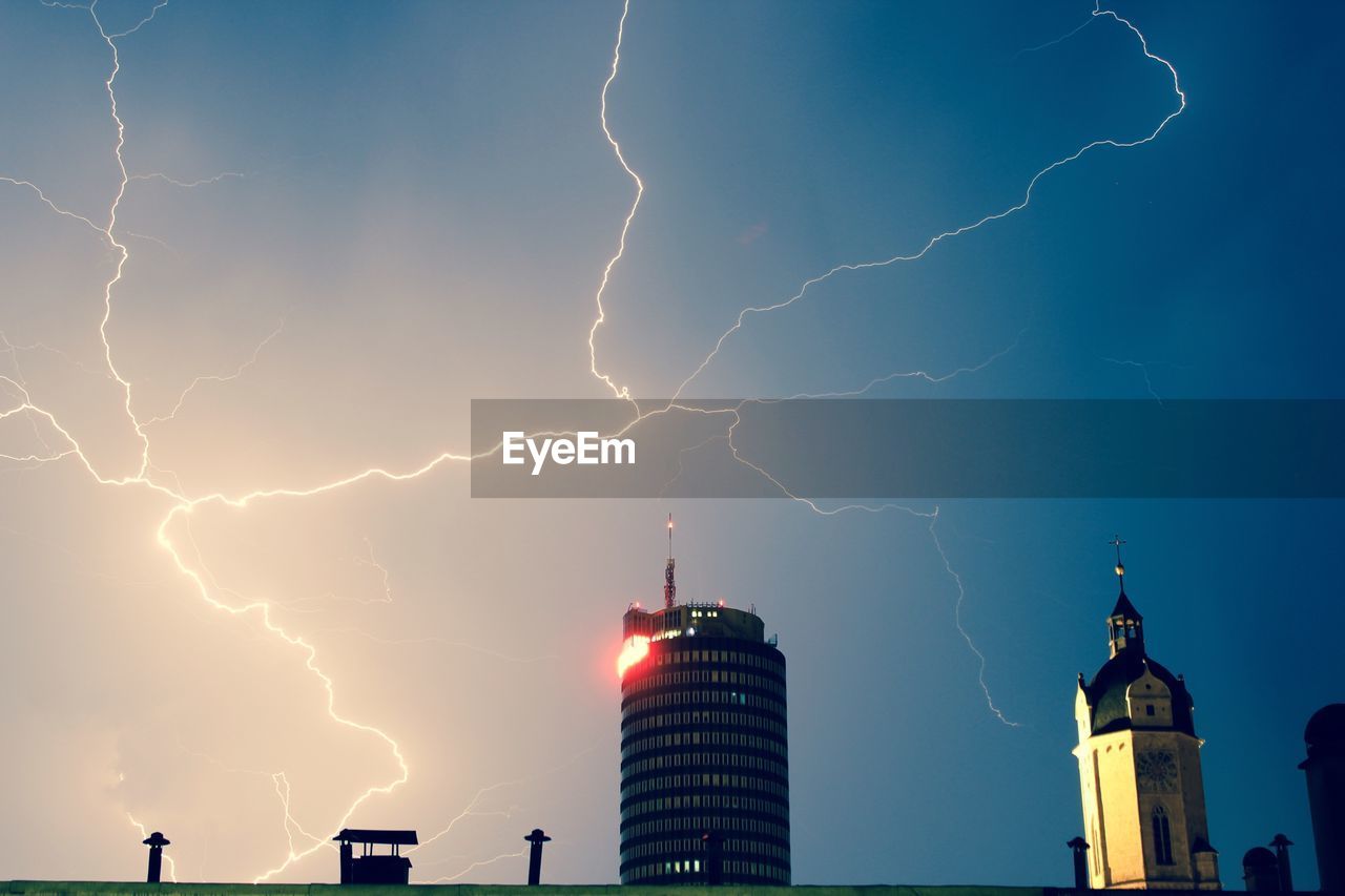 Buildings against sky during thunderstorm