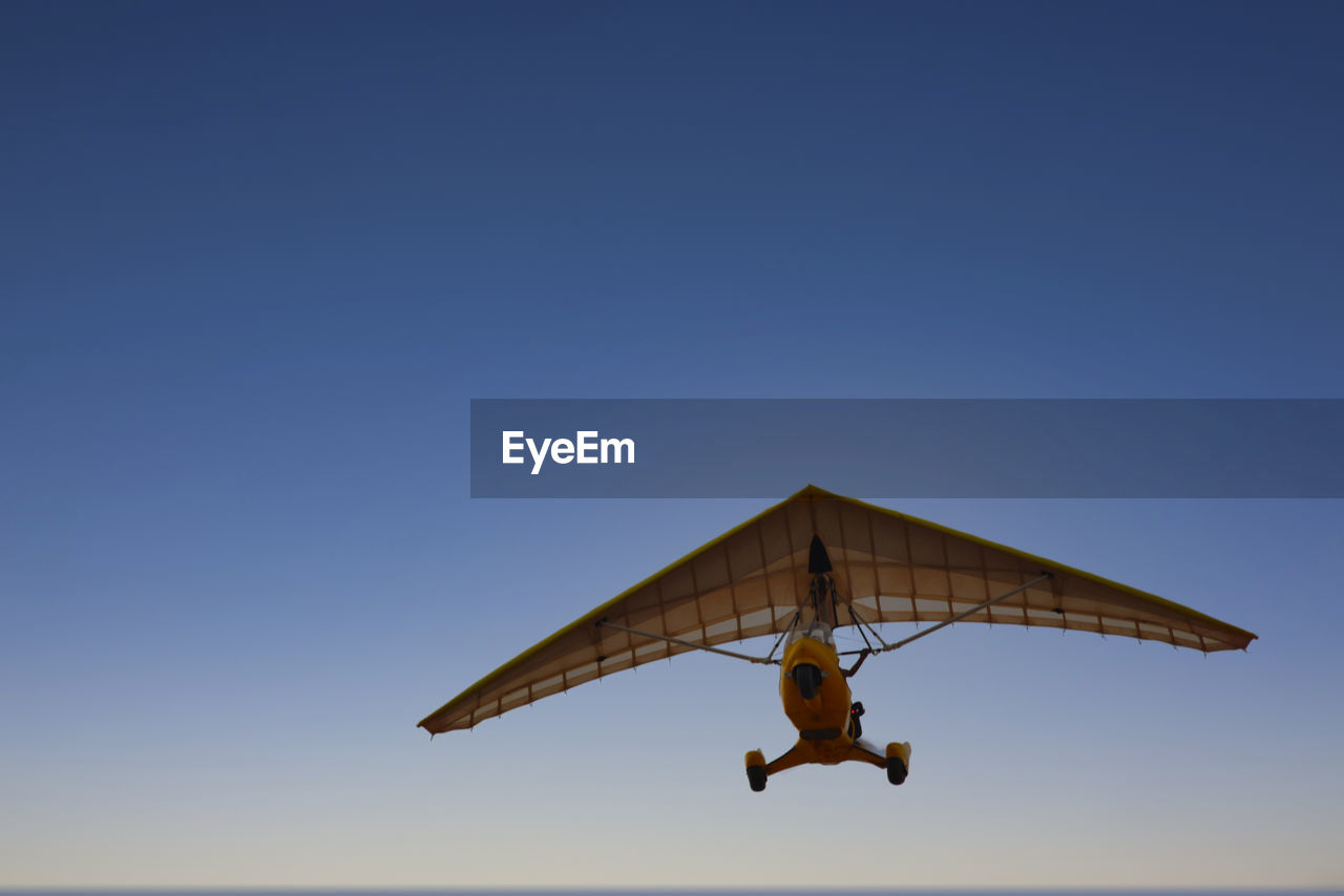 Gliding in a mini plane in a low angle view. 