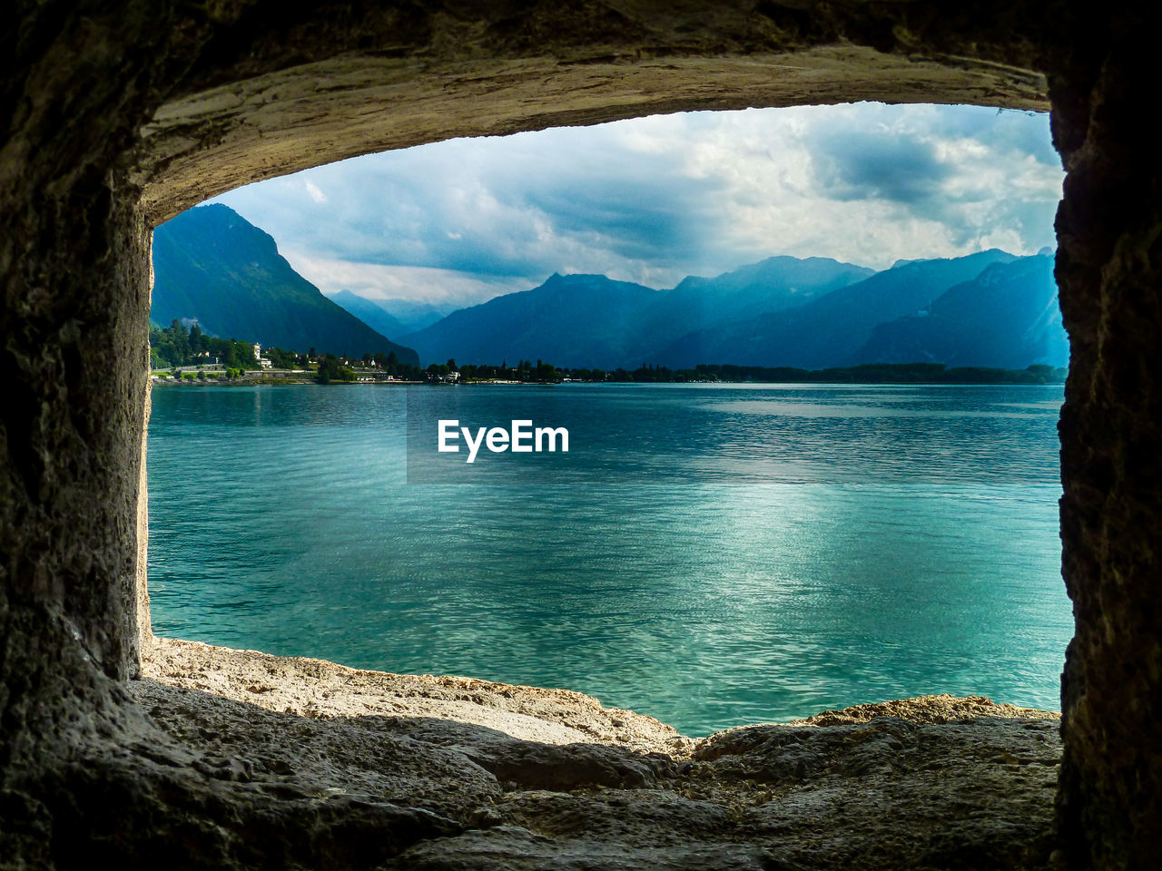 SCENIC VIEW OF SEA WITH MOUNTAIN RANGE IN BACKGROUND