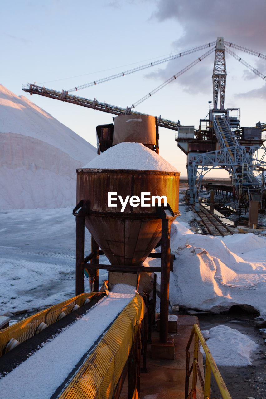 SNOW COVERED INDUSTRY AGAINST SKY