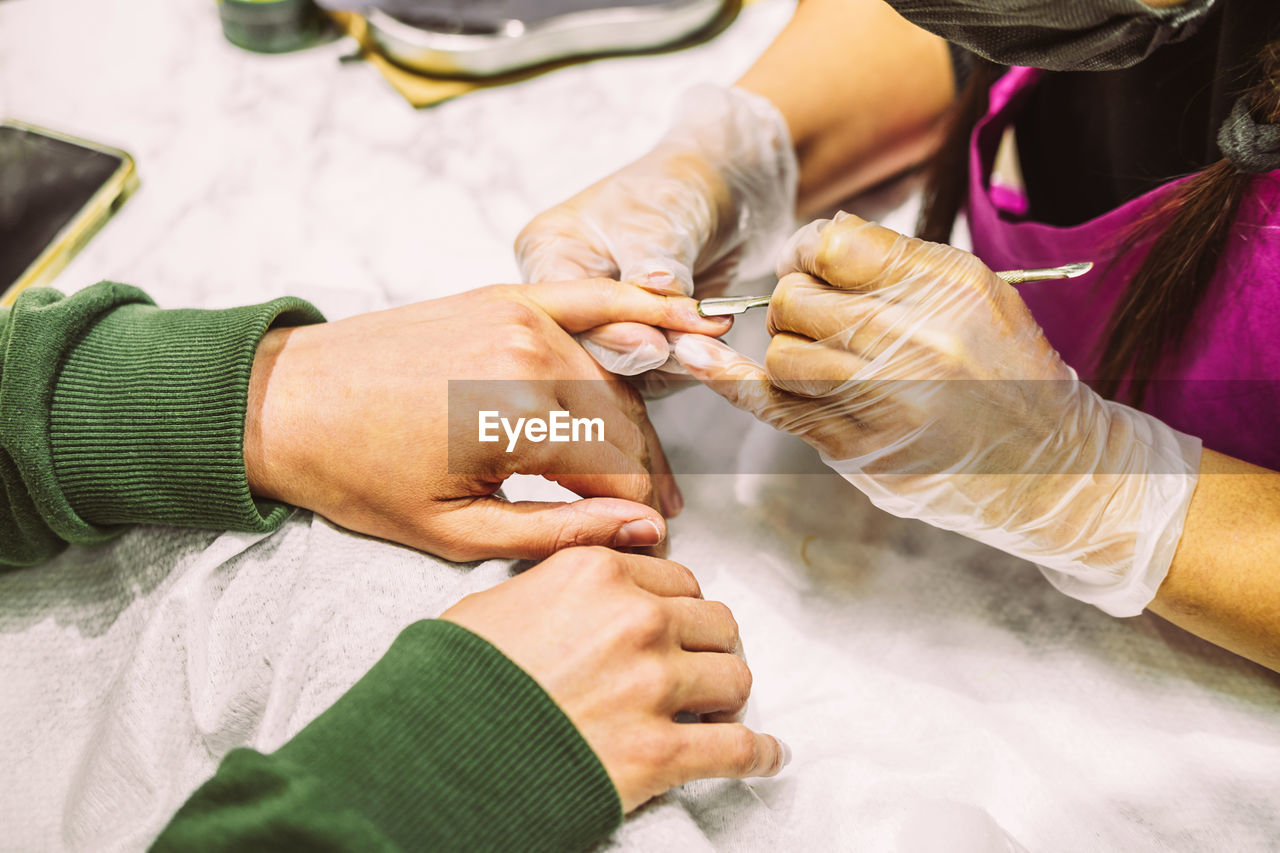 Women's hands in the manicure process close-up