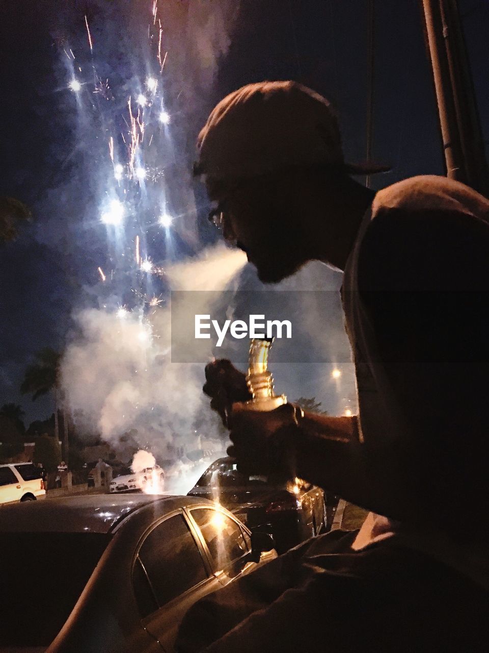 REFLECTION OF MAN ON BARBECUE GRILL