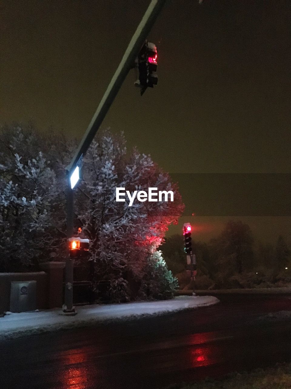 MAN ON ILLUMINATED STREET AT NIGHT