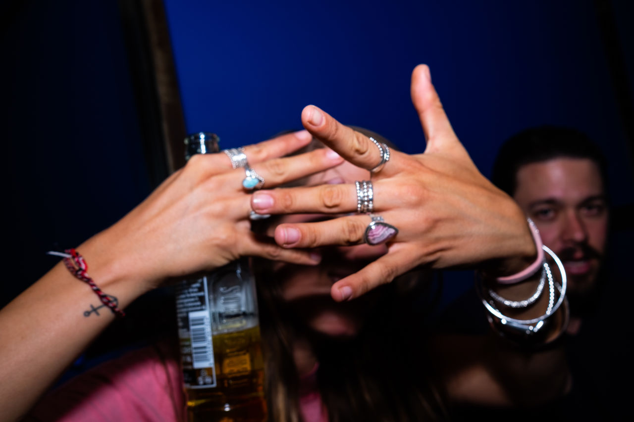 MIDSECTION OF WOMAN HOLDING HANDS WITH PEOPLE