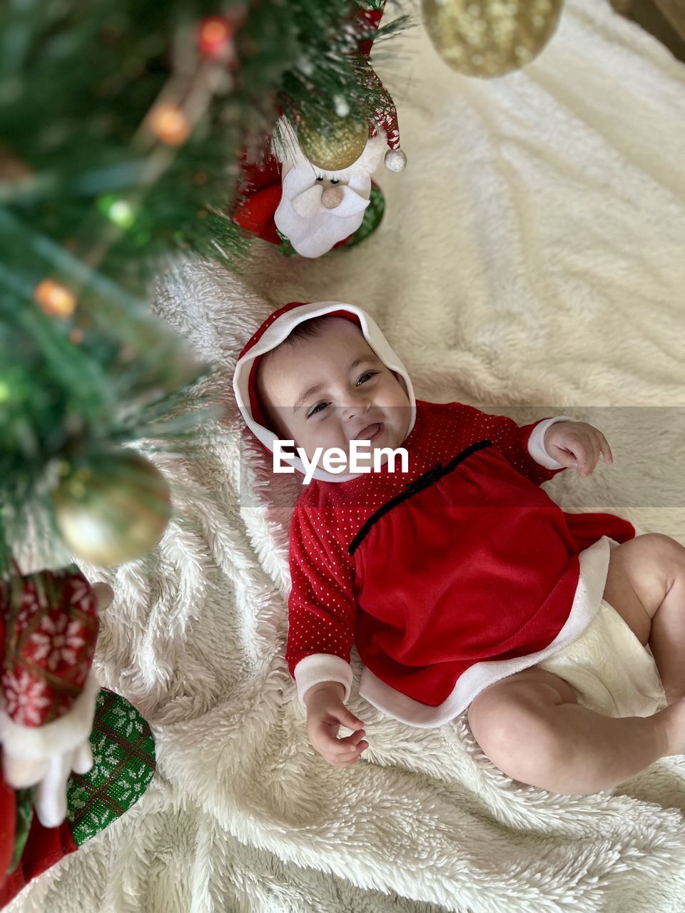 high angle view of cute baby girl lying on bed at home