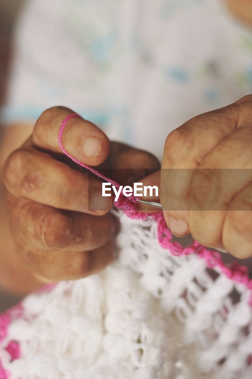 CLOSE-UP OF HAND HOLDING STUFFED