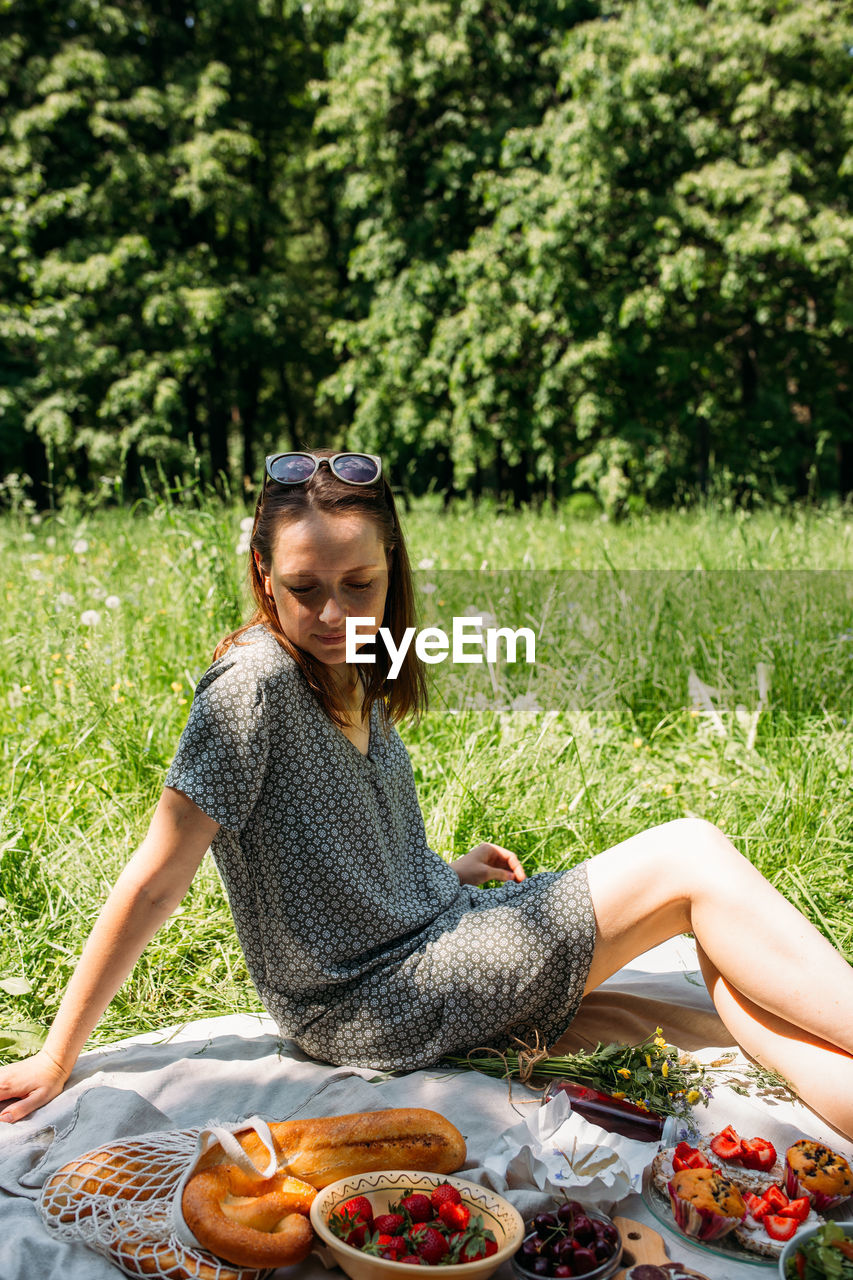 portrait of young woman sitting on grass