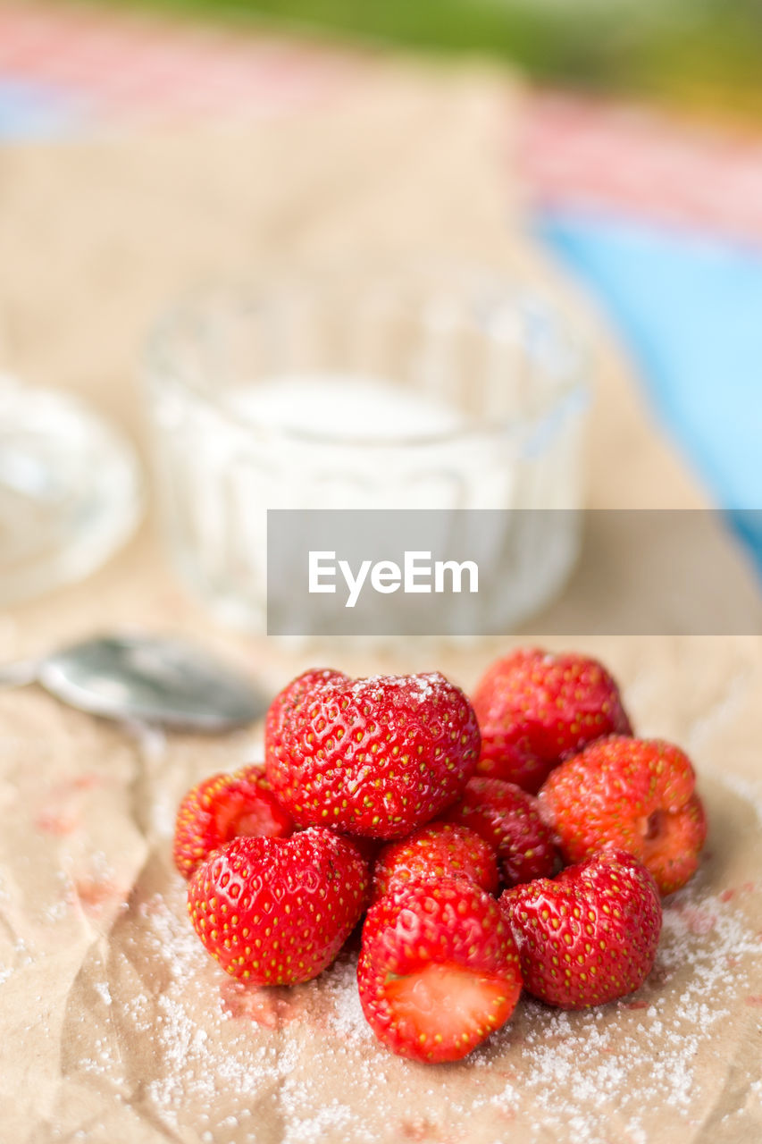 CLOSE-UP OF STRAWBERRIES AND RASPBERRIES ON TABLE