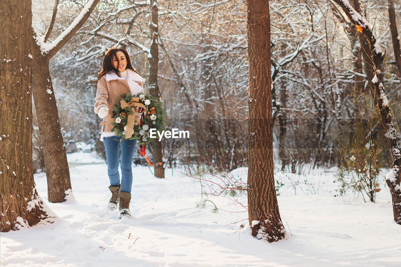 FULL LENGTH OF WOMAN IN SNOW COVERED FIELD